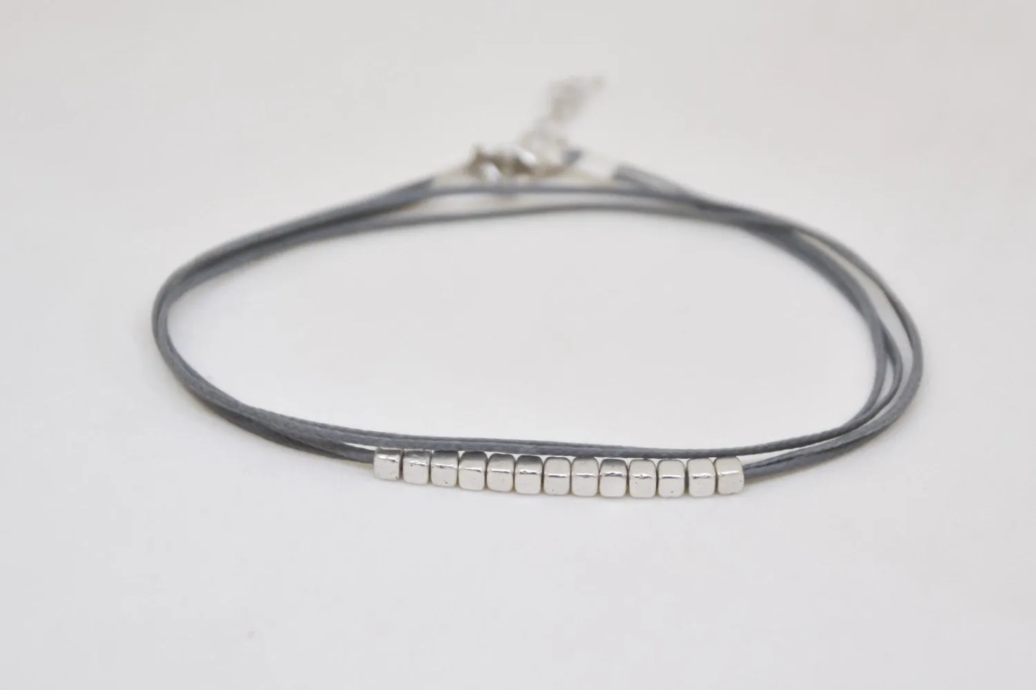 Wrapped gray ankle bracelet with matt silver nugget beads cubes